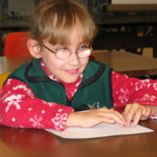 A young visually impaired girl in the newly-created CarrollKids summer program practices her braille.