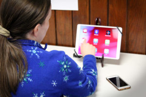 A woman explores the built-in magnifier on an iPad at the Carroll Center's Assistive Technology Device Lab.