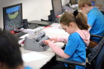 In a classroom, Hannah Gevers competes alongside other students during the Braille challenge.