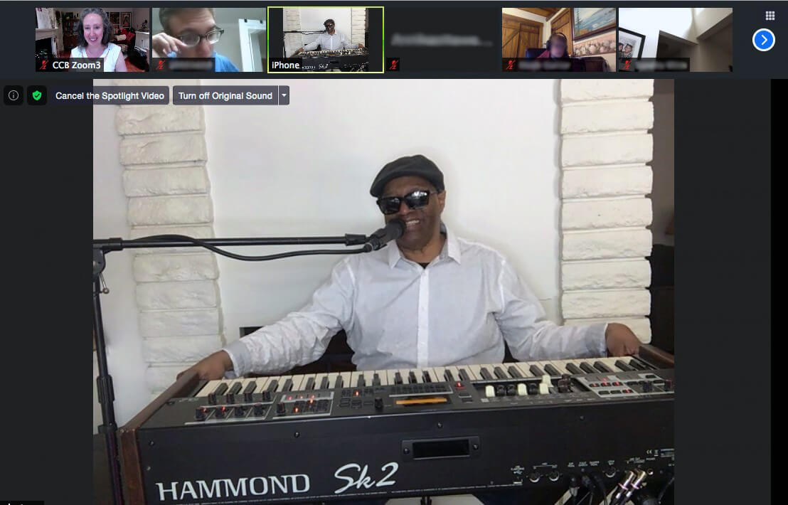The legendary Ellis Hall smiles while seated behind a Hammond piano keyboard as he talks to students in the Introduction to Careers in Music program through Zoom.