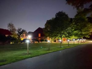 Nearly a dozen illuminated solar light posts line the Carroll Center for the Blind driveway at dusk.