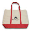 Carroll Center for the Blind Tote Bag features beige canvas material on the body of the tote. The handles and bottom of the tote bag are pink. A small, black Carroll Center for the Blind logo appears on the middle of the tote.