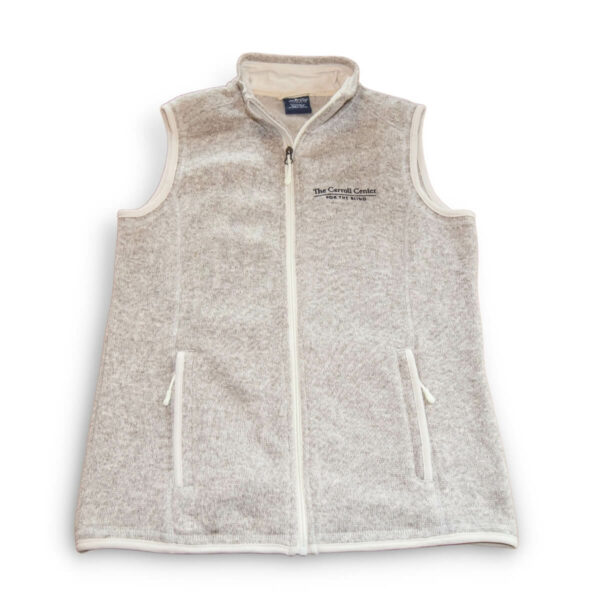 Heather Oatmeal colored fleece vest. On the left breast pocket is the Carroll Center for the Blind logo in black stitching.