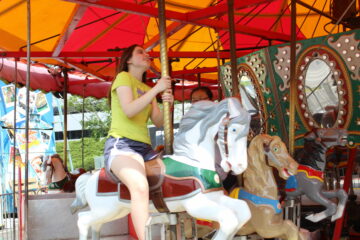 Teenage girl on horse in carousel