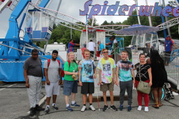 5 Carroll teens and 2 supervisors in front of a Ferriss wheel