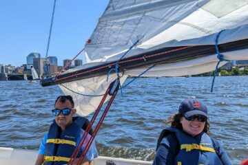 A carroll kid and supervisor on the open river on sailboat