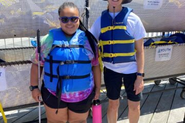 a teenage girl and a lady in a life vest posing for the camera with sunglasses