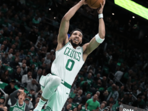 Jayson Tatum of the Boston Celtics rises up to dunk the ball during a game.