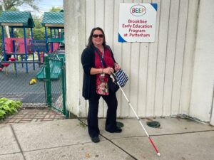 Holly Polgreen stands outside the Brookline Early Education Program at Putterham.