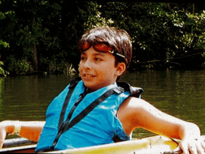 A young Jack Duffy-Protentis kayaking while attending a Carroll Center summer program.