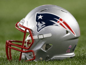 New England Patriots helmet laid on the football field at Gillette Stadium.