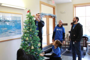 A group of corporate volunteers decorating a Christmas Tree