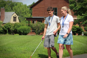 Carroll Center instructor with a client during an Orientation & Mobility lesson on campus