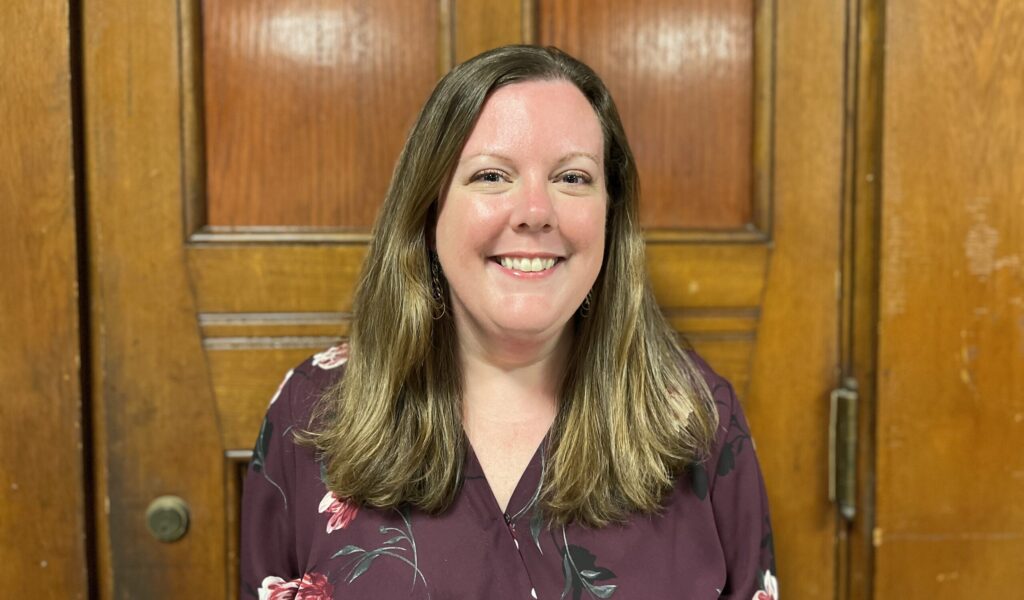 Headshot of Sheila Carney. She is a white woman with long light brown hair.