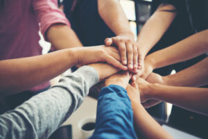 Top view of people holding hands together