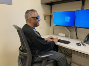 Client Working on the Computer and Smiling