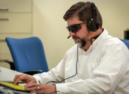 Client Aaron Spelker working on a computer as part of the center’s tech services program