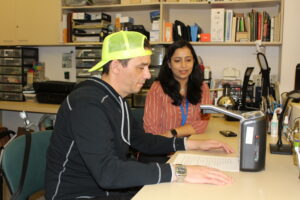 Low vision therapist is working with a client using assistive technology