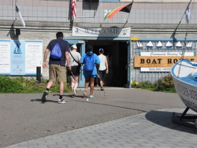 photo of a group of blind sailors walking into the entrance of the Community Boating boat hourse.