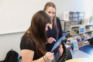 Ed Services Photo - TVI helping TVI is helping a student who is using a tablet device.