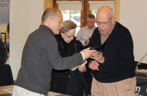A senior low vision client receiving training with their smartphone