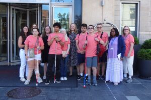 Summer Students Group A group of students with white canes standing in front of a college building